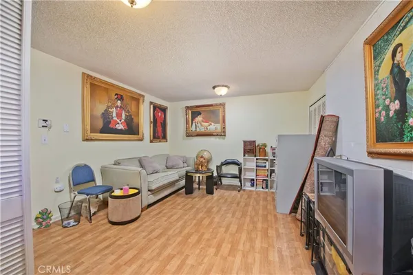 a view of a kitchen with fridge and wooden floor