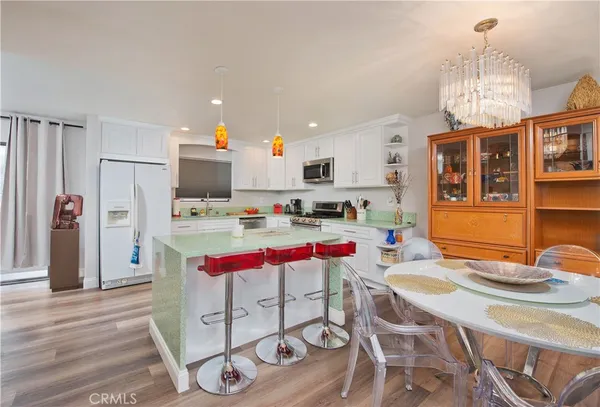 a kitchen with stainless steel appliances kitchen island granite countertop a sink and cabinets