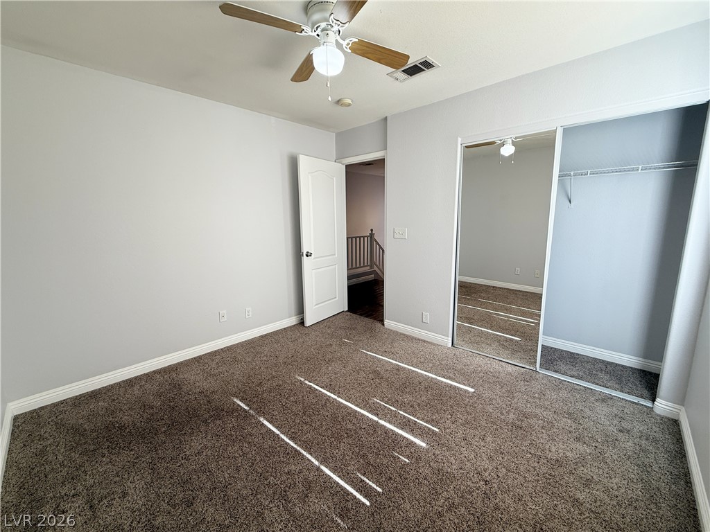 2185 Polynesia Circle Henderson, NV 89074 - Photo 19 of 37 A well-lit bedroom features plush carpeting and convenient mirrored closet doors.