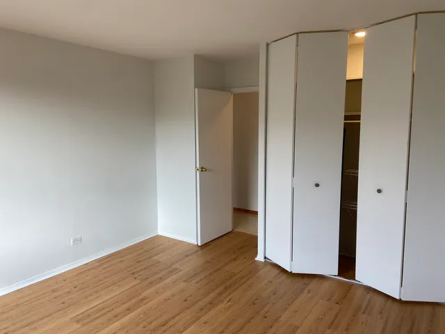 a view of hallway with wooden floor