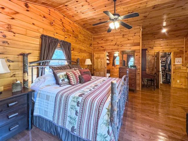 a view of a bedroom with furniture and windows