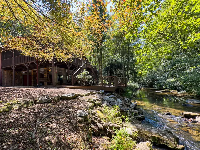 a view of a house with a yard and sitting area