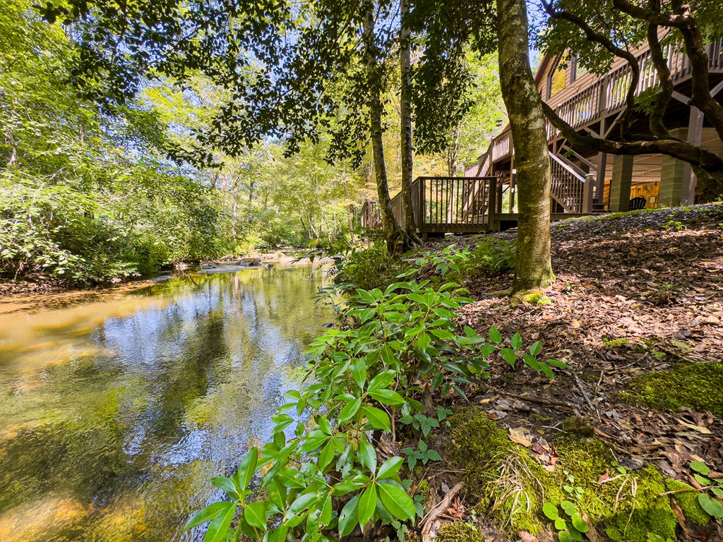 277 Virginia Lane Murphy, NC 28906 - Photo 46 of 63 a backyard of a house with lots of green space and lake view