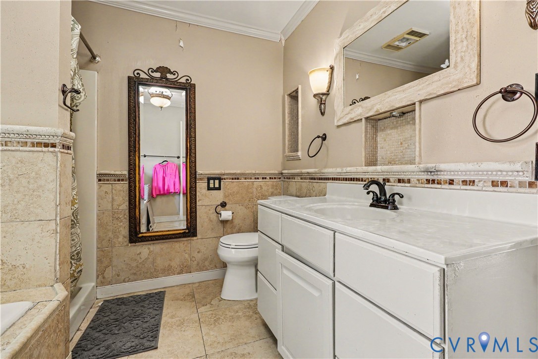 4803 Coleman Road Richmond, VA 23230 - Photo 22 of 54 White vanity with a single basin, dark bronze fauc