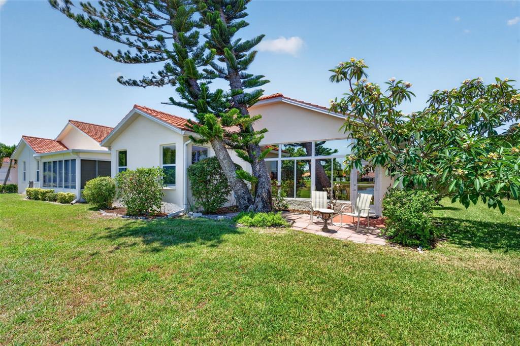 4266 Summertree Road Venice, FL 34293 - Photo 36 of 64 a view of a house with a yard and sitting area