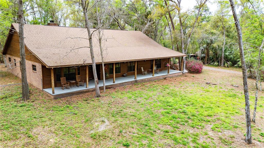 17055 Sweetwater Road Dade City, FL 33523 - Photo 13 of 53 a view of a house with a yard balcony and tree