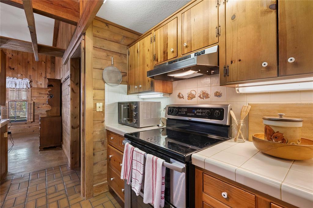 17055 Sweetwater Road Dade City, FL 33523 - Photo 17 of 53 a kitchen with a stove and a microwave
