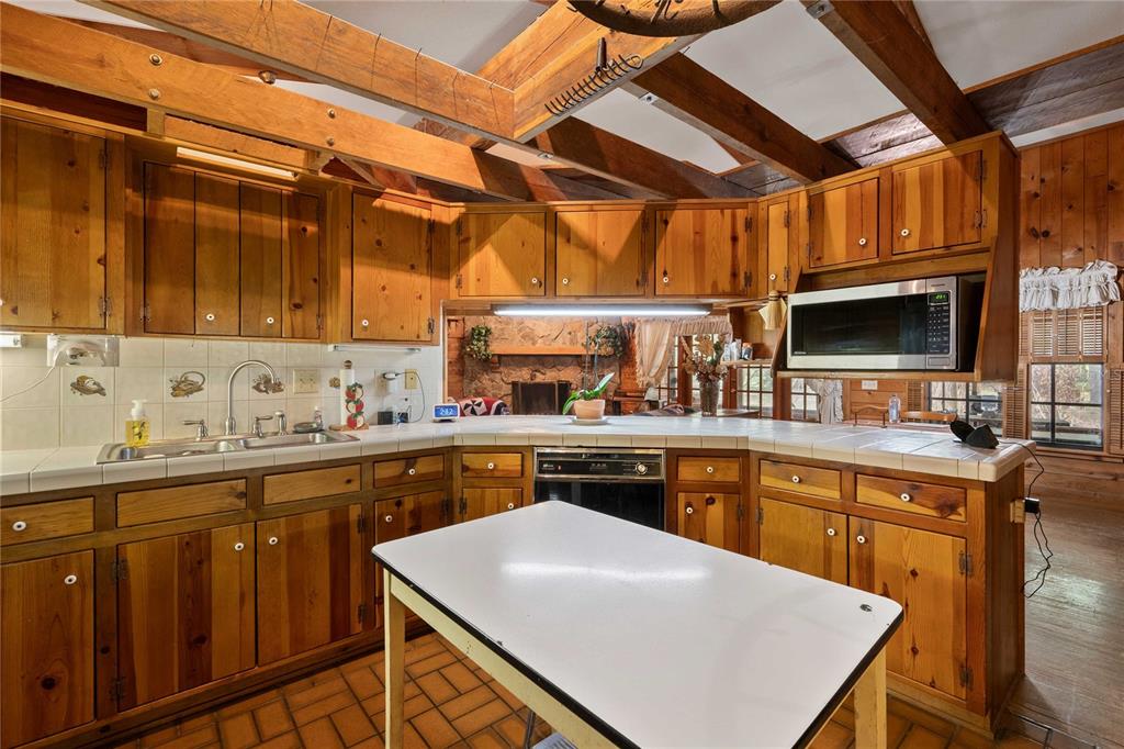 17055 Sweetwater Road Dade City, FL 33523 - Photo 18 of 53 a kitchen with stainless steel appliances granite countertop a sink and cabinets