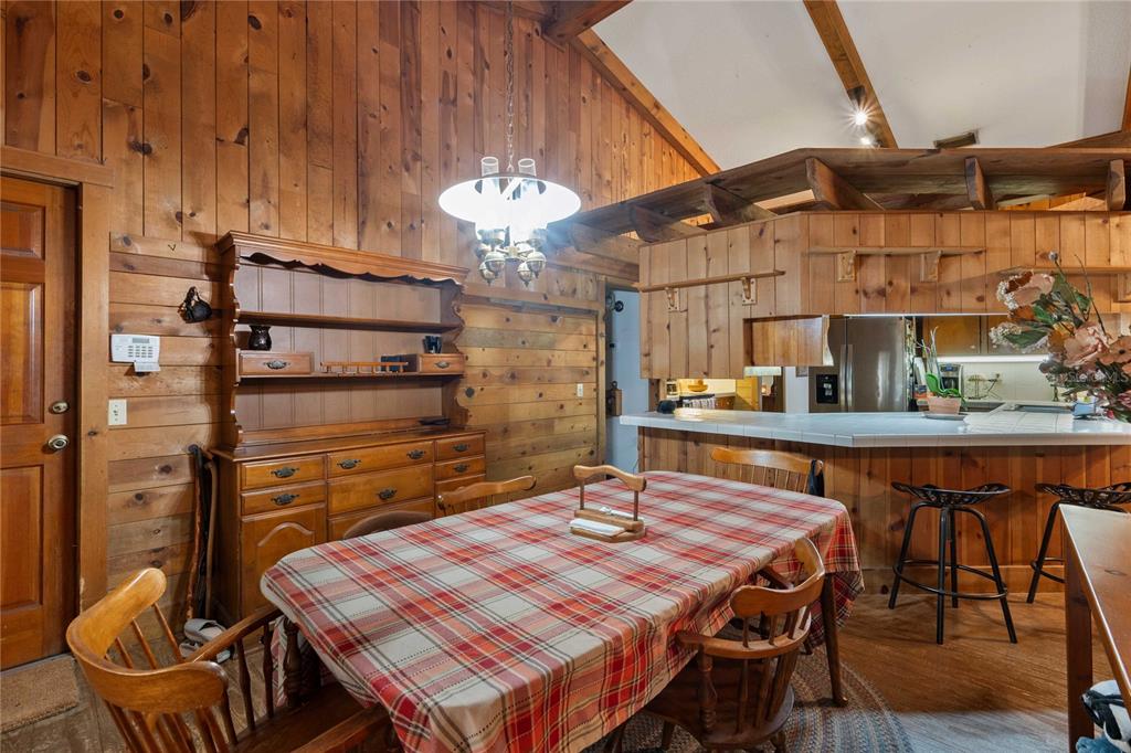 17055 Sweetwater Road Dade City, FL 33523 - Photo 20 of 53 a dining room with a wooden table and chairs