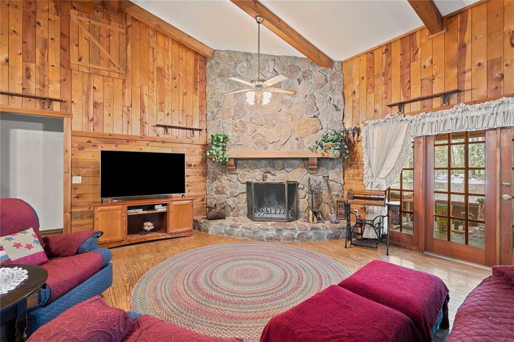 17055 Sweetwater Road Dade City, FL 33523 - Photo 23 of 53 a living room with furniture a flat screen tv and a fireplace