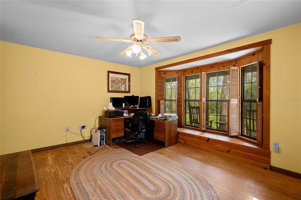 17055 Sweetwater Road Dade City, FL 33523 - Photo 24 of 53 a bedroom with a bed and a large window