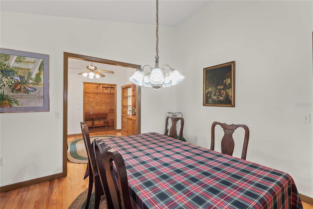 17055 Sweetwater Road Dade City, FL 33523 - Photo 28 of 53 a bedroom with a bed and a chandelier