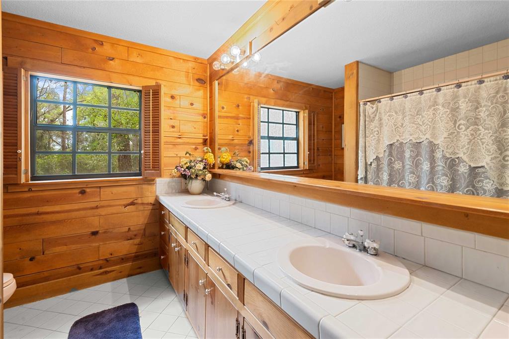 17055 Sweetwater Road Dade City, FL 33523 - Photo 31 of 53 a bathroom with a sink and a large window