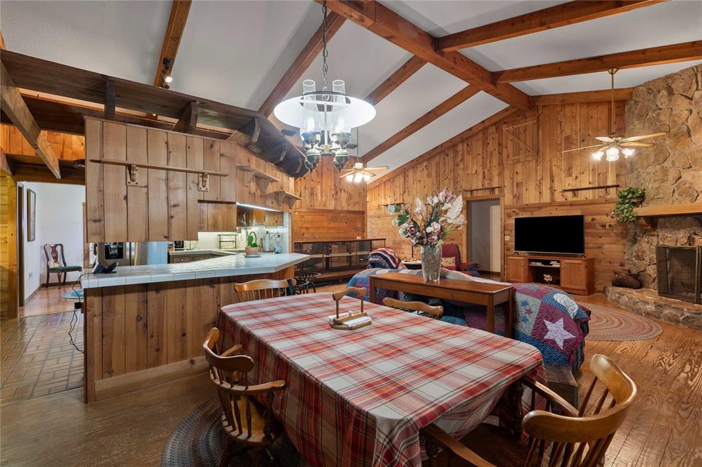 17055 Sweetwater Road Dade City, FL 33523 - Photo 36 of 53 a view of a dining room with furniture a chandelier and wooden floor