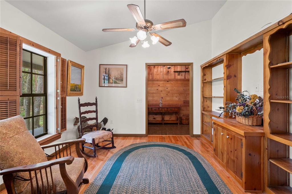 17055 Sweetwater Road Dade City, FL 33523 - Photo 37 of 53 a view of a livingroom with furniture hardwood floor and a ceiling fan