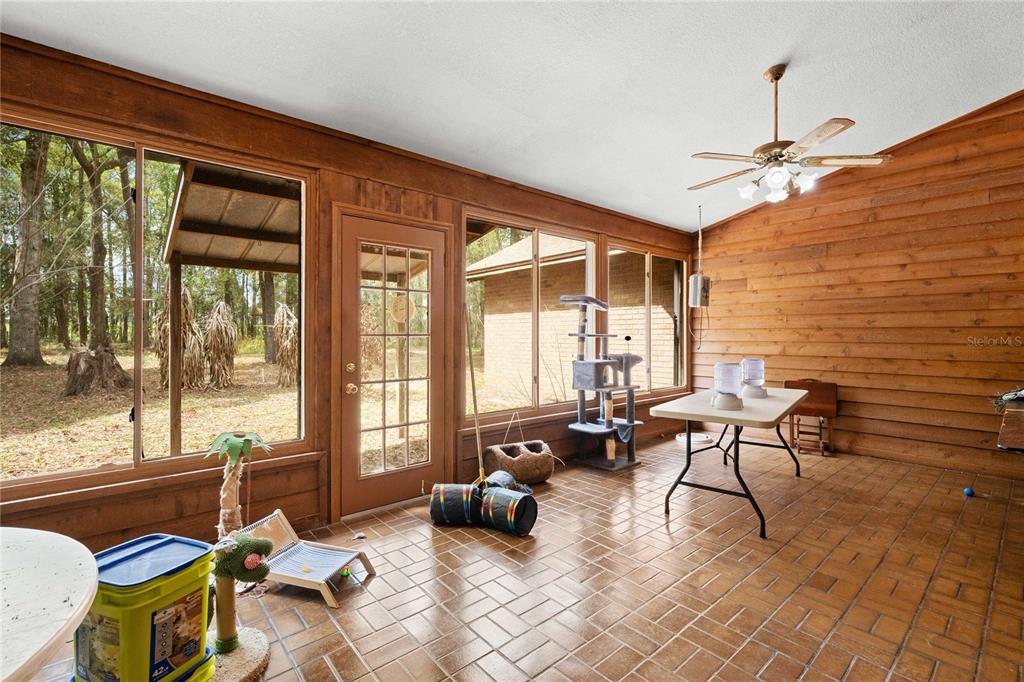 17055 Sweetwater Road Dade City, FL 33523 - Photo 38 of 53 a living room with furniture and a floor to ceiling window