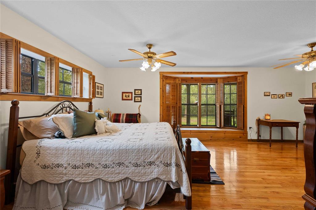 17055 Sweetwater Road Dade City, FL 33523 - Photo 43 of 53 a bedroom with a bed and a large window with outer view