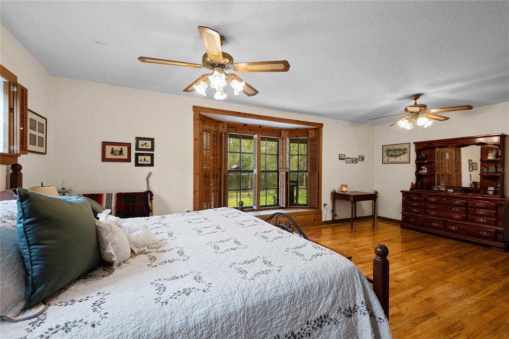 17055 Sweetwater Road Dade City, FL 33523 - Photo 44 of 53 a bedroom with a bed couch and window