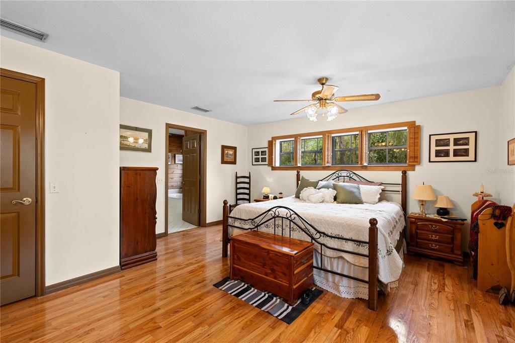 17055 Sweetwater Road Dade City, FL 33523 - Photo 47 of 53 a bedroom with furniture and wooden floor