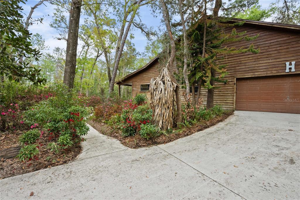 17055 Sweetwater Road Dade City, FL 33523 - Photo 6 of 53 a front view of a house with garden