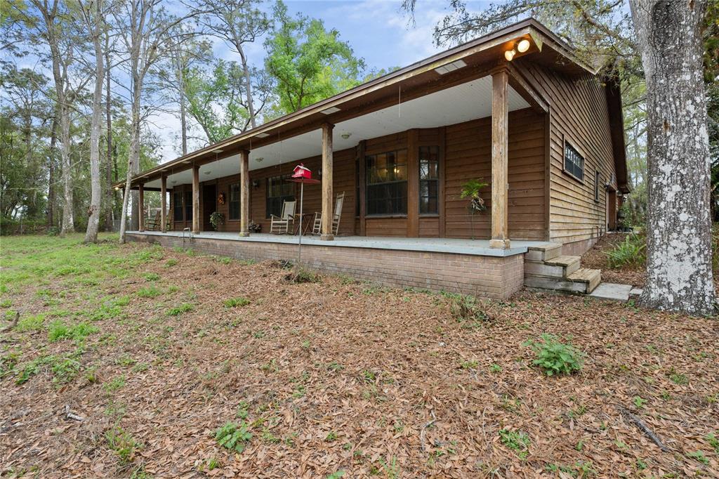 17055 Sweetwater Road Dade City, FL 33523 - Photo 7 of 53 a front view of a house with a yard