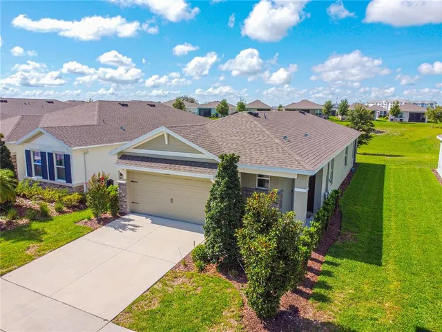 an aerial view of a house with garden space and outdoor seating
