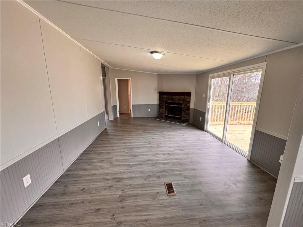 8405 Alda Road Stokesdale, NC 27357 - Photo 23 of 47 Huge den with new sliding glass doors that exit to the largest porch on the back of the home