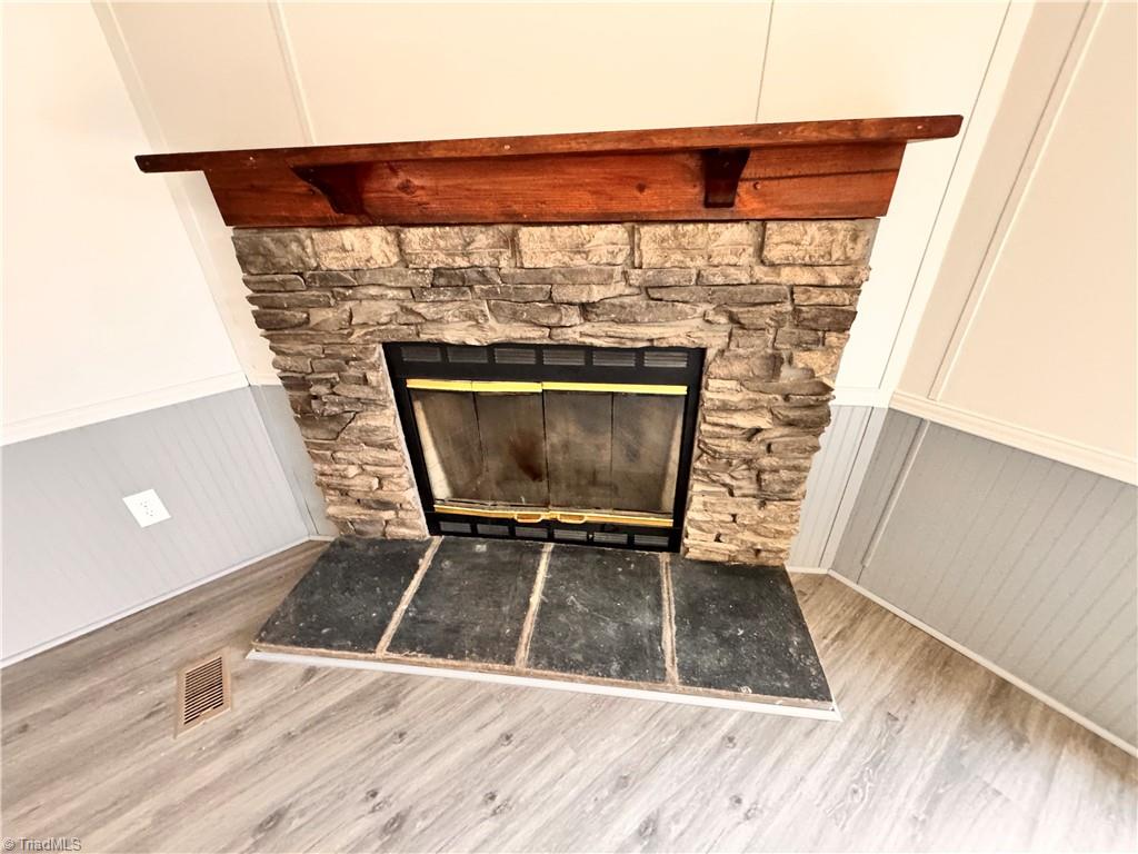8405 Alda Road Stokesdale, NC 27357 - Photo 25 of 47 stone wood burning fireplace that has a blower on it. Can go wood burning or add gas logs
