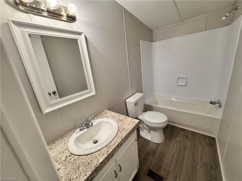 8405 Alda Road Stokesdale, NC 27357 - Photo 37 of 47 Hall bathroom with new tub and surround, new countertop and commode
