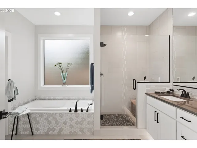 a bathroom with a tub sink and mirror