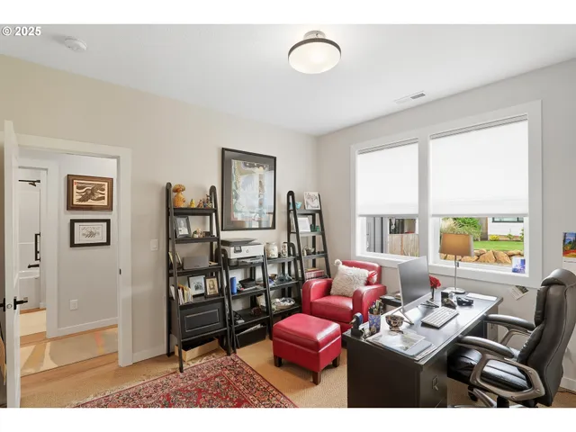 a living room with furniture and a floor to ceiling window