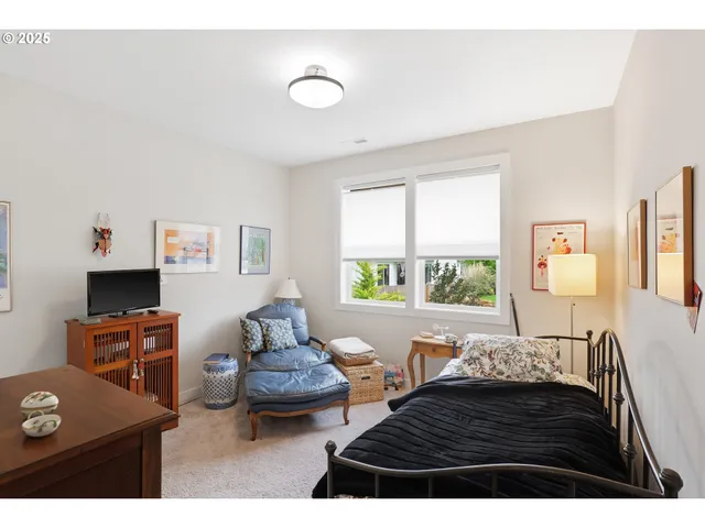a bedroom with furniture and a window