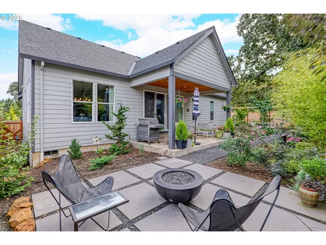 a view of a patio with table and chairs and potted plants