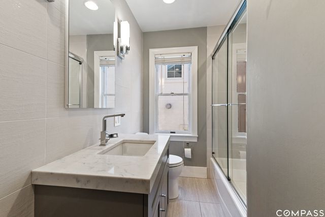 a bathroom with a sink a mirror and a shower