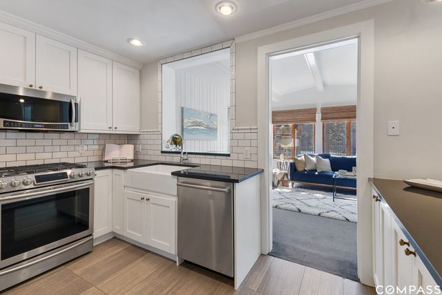a kitchen with a stove a sink and a microwave