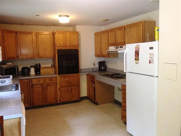 250 Plumtree Road Sunderland, MA 01375 - Photo 3 of 9 a kitchen with stainless steel appliances granite countertop a refrigerator stove a sink dishwasher and wooden cabinets