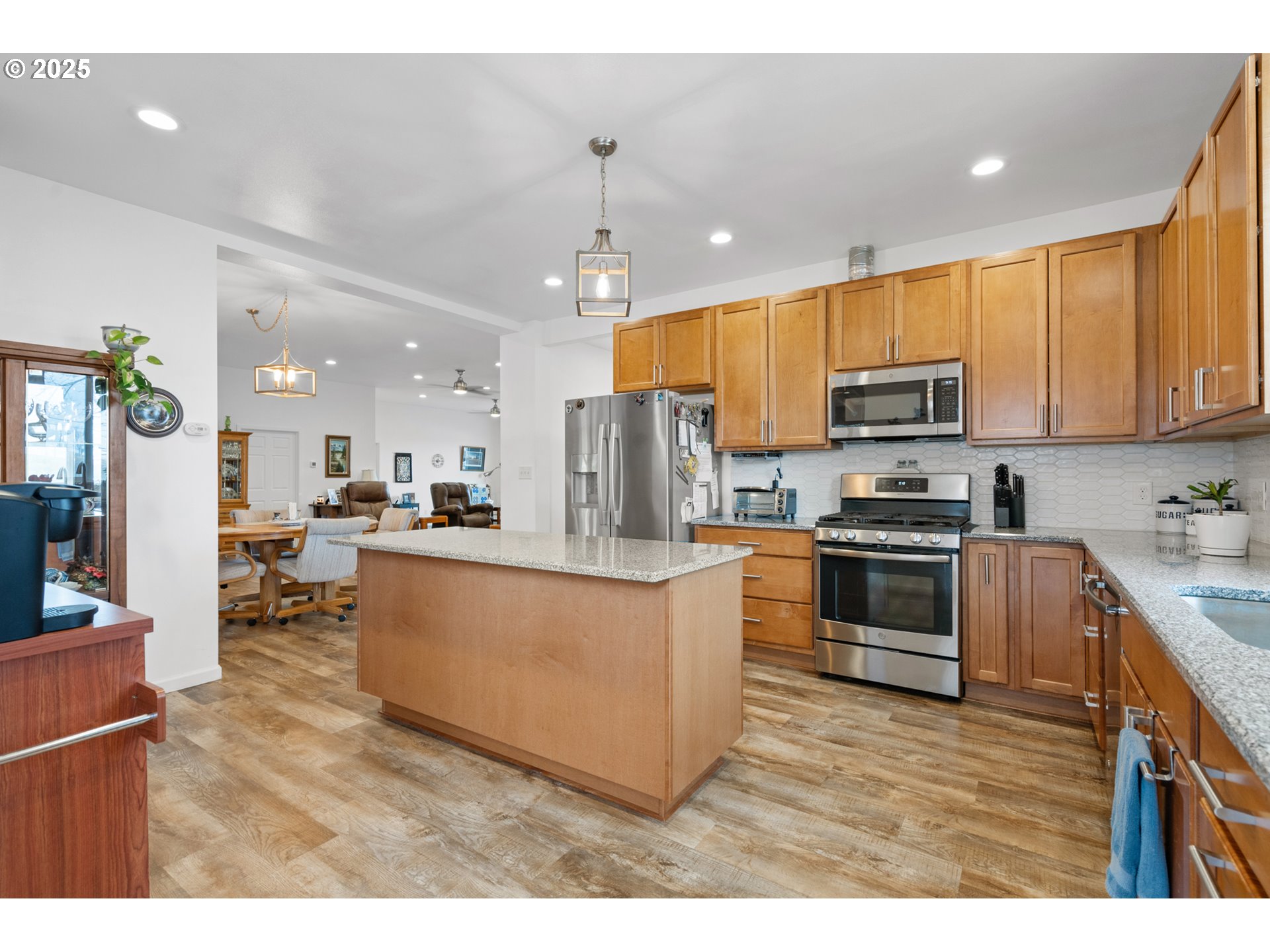 402 East Main Street Weston, OR 97886 - Photo 16 of 36 a kitchen with kitchen island a sink cabinets and stainless steel appliances