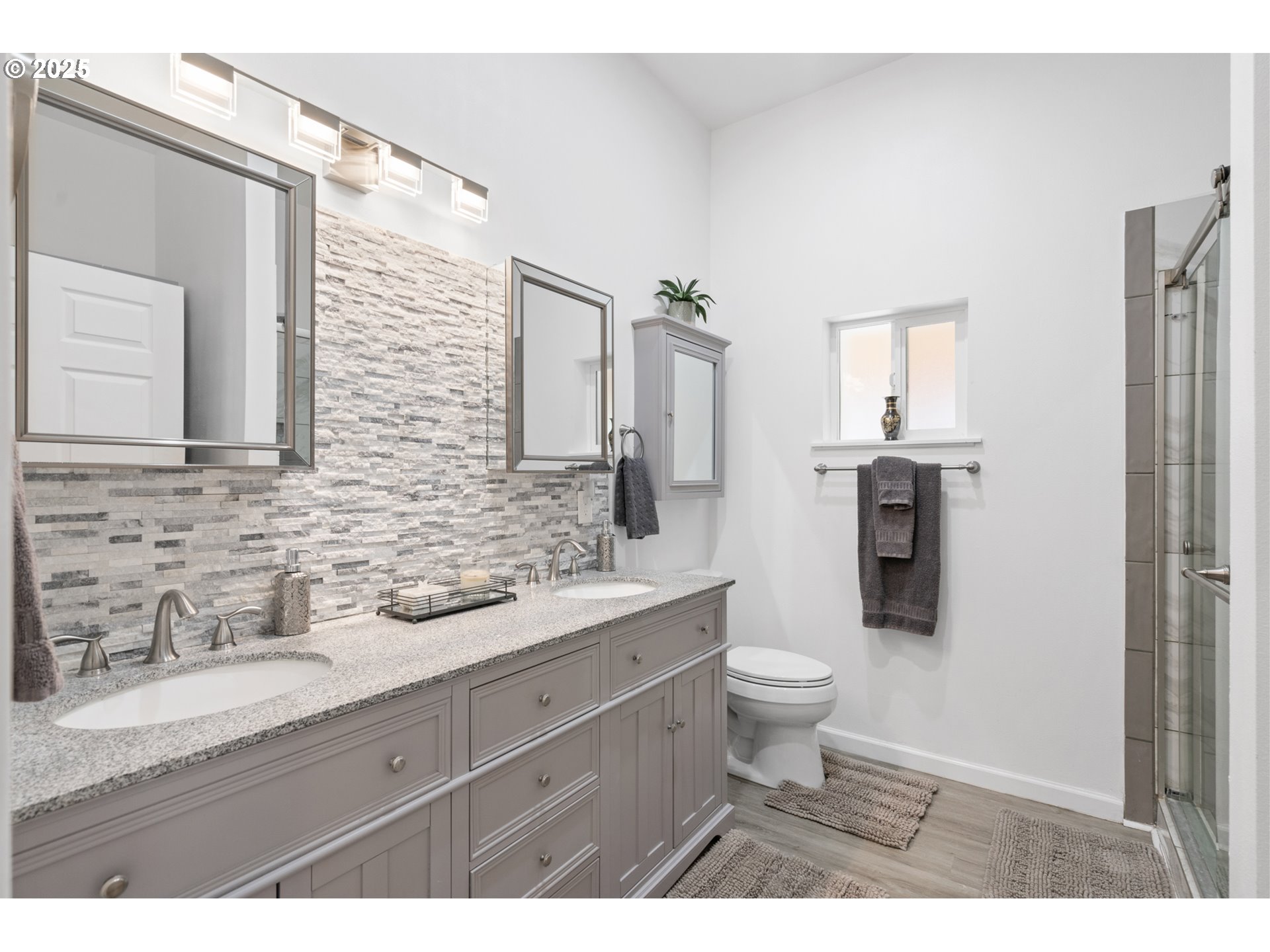 402 East Main Street Weston, OR 97886 - Photo 21 of 36 a bathroom with a granite countertop sink a toilet a mirror and shower