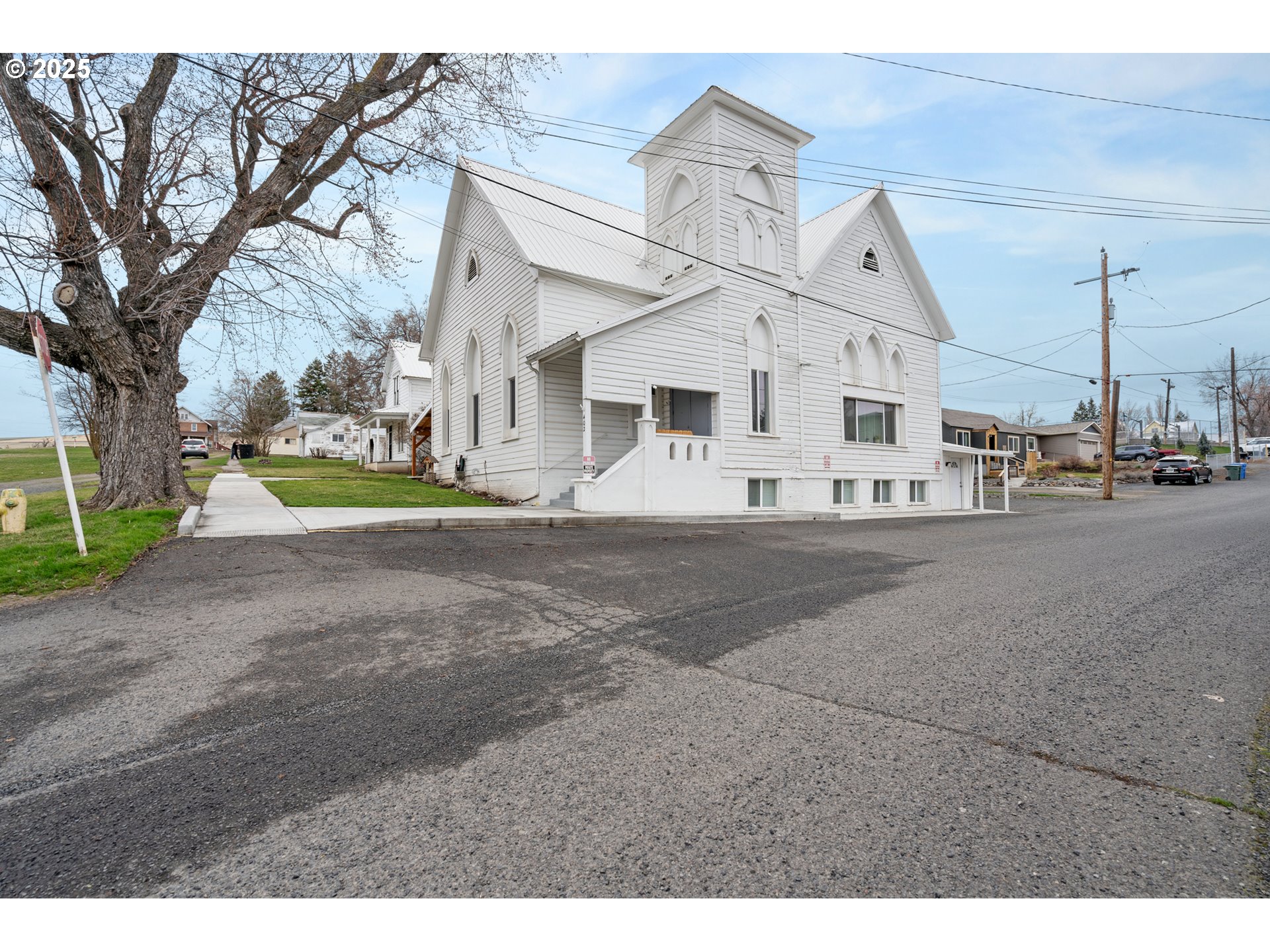 402 East Main Street Weston, OR 97886 - Photo 4 of 36 a view of a white house with a big yard and large trees