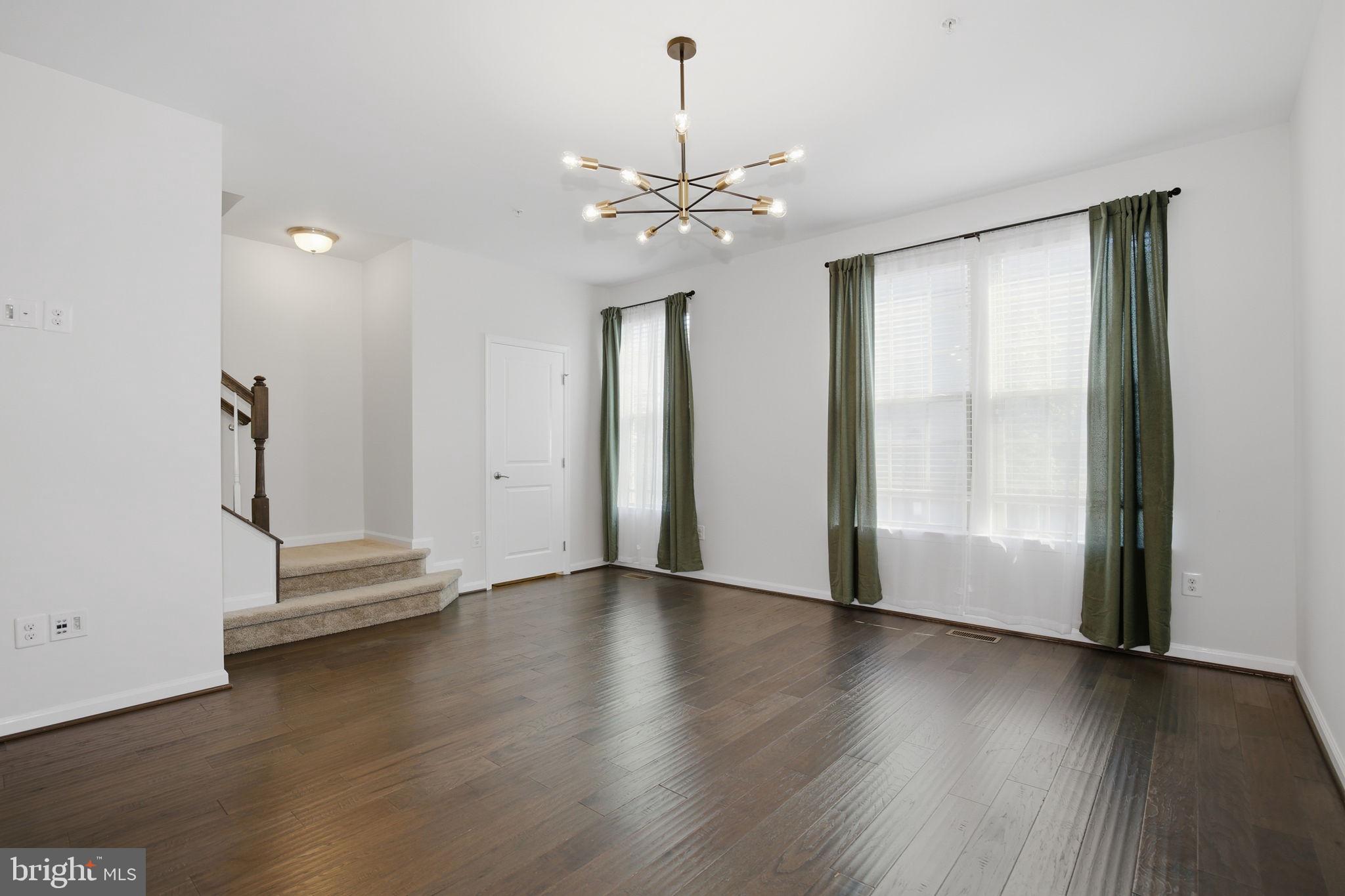 2784 Fredericksburg Road Hanover, MD 21076 - Photo 25 of 60 an empty room with wooden floor chandelier and windows