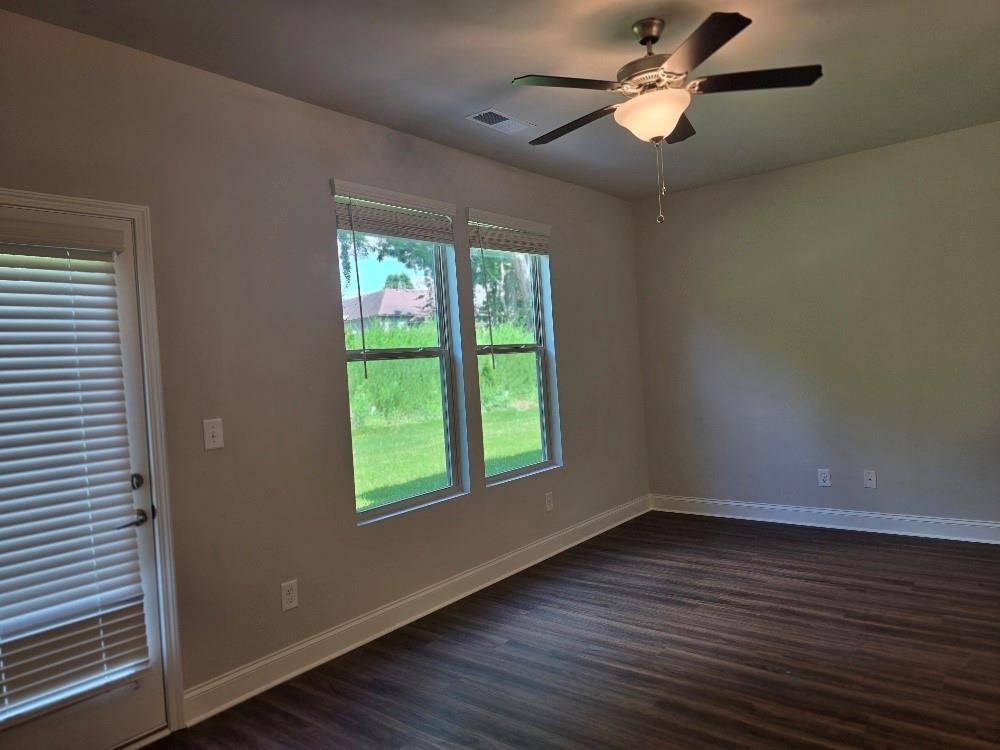 6194 Ripple Way, Unit 86 Atlanta, GA 30349 - Photo 11 of 27 a view of an empty room with wooden floor and a window