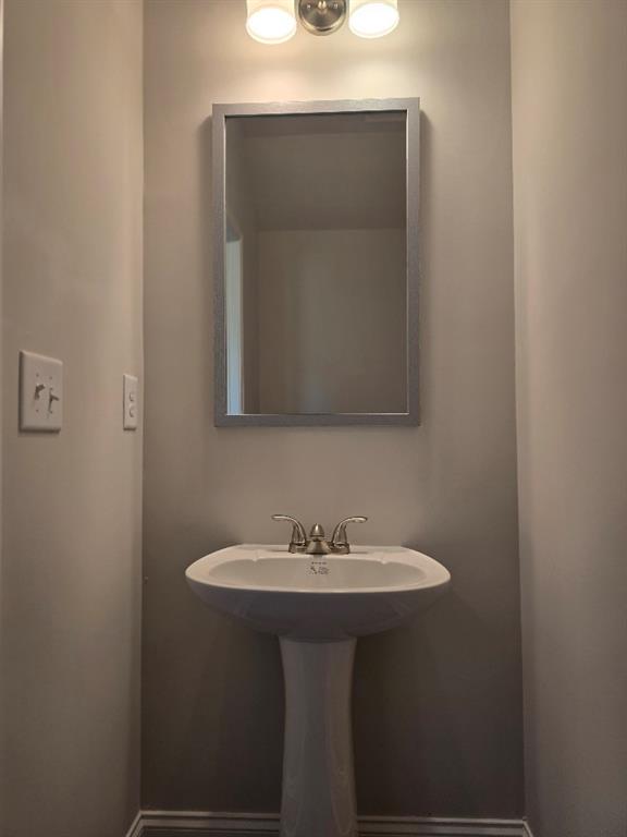 6194 Ripple Way, Unit 86 Atlanta, GA 30349 - Photo 13 of 27 a bathroom with a sink and a mirror