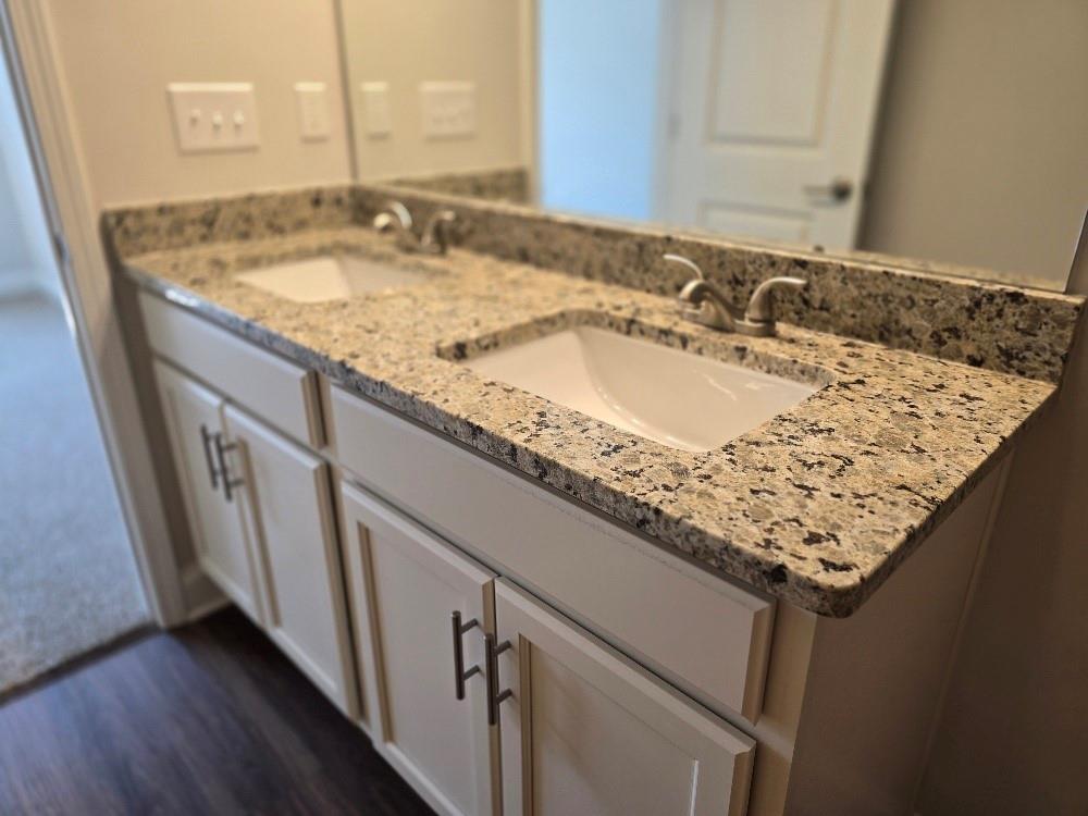 6194 Ripple Way, Unit 86 Atlanta, GA 30349 - Photo 22 of 27 a bathroom with sink and mirror