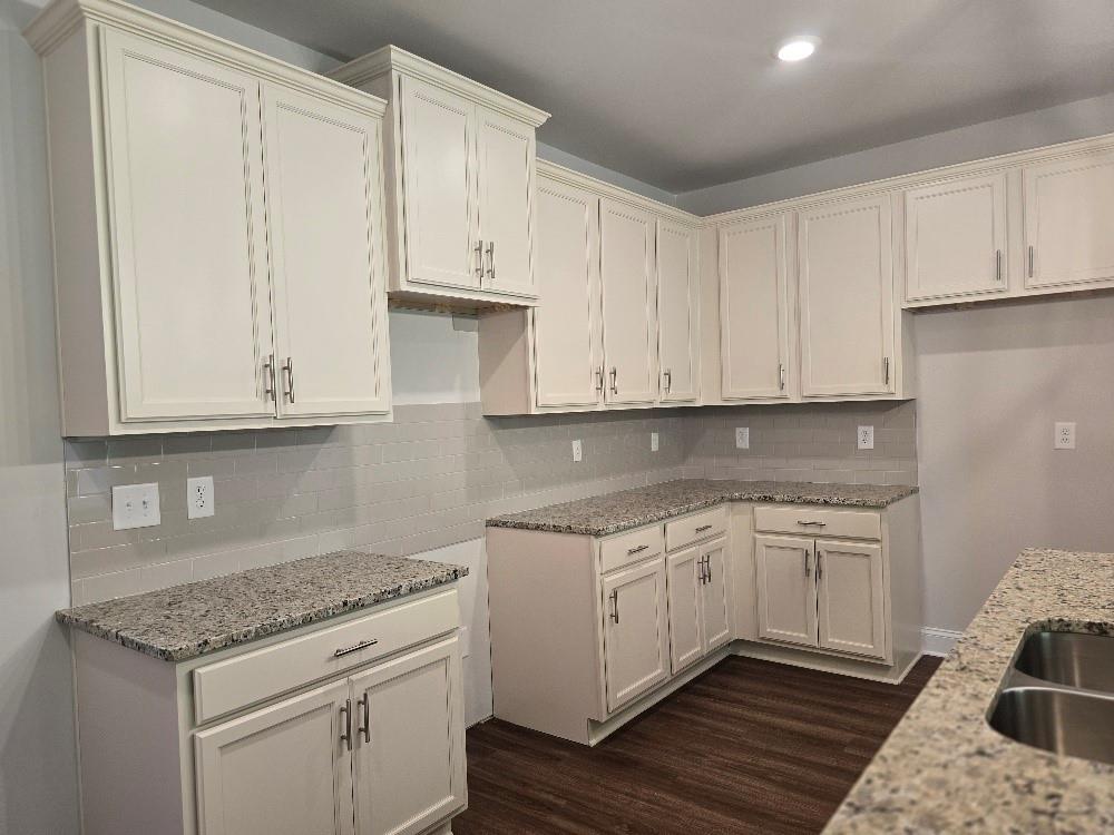 6194 Ripple Way, Unit 86 Atlanta, GA 30349 - Photo 4 of 27 a kitchen with stainless steel appliances granite countertop a sink and cabinets with wooden floor