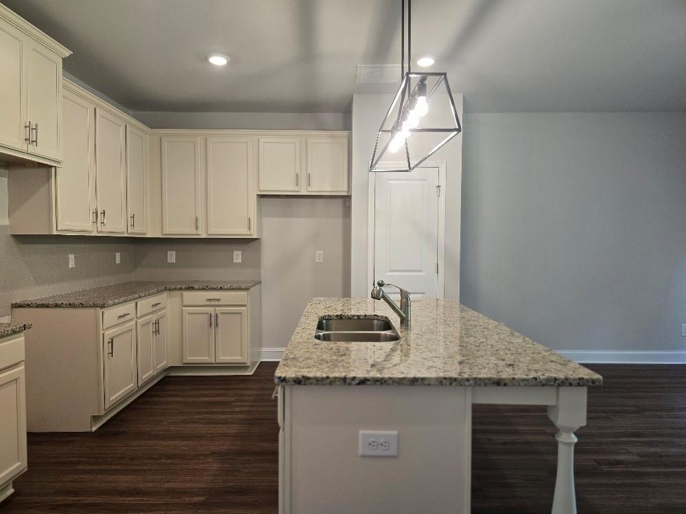 6194 Ripple Way, Unit 86 Atlanta, GA 30349 - Photo 6 of 27 a kitchen with sink cabinets and wooden floor