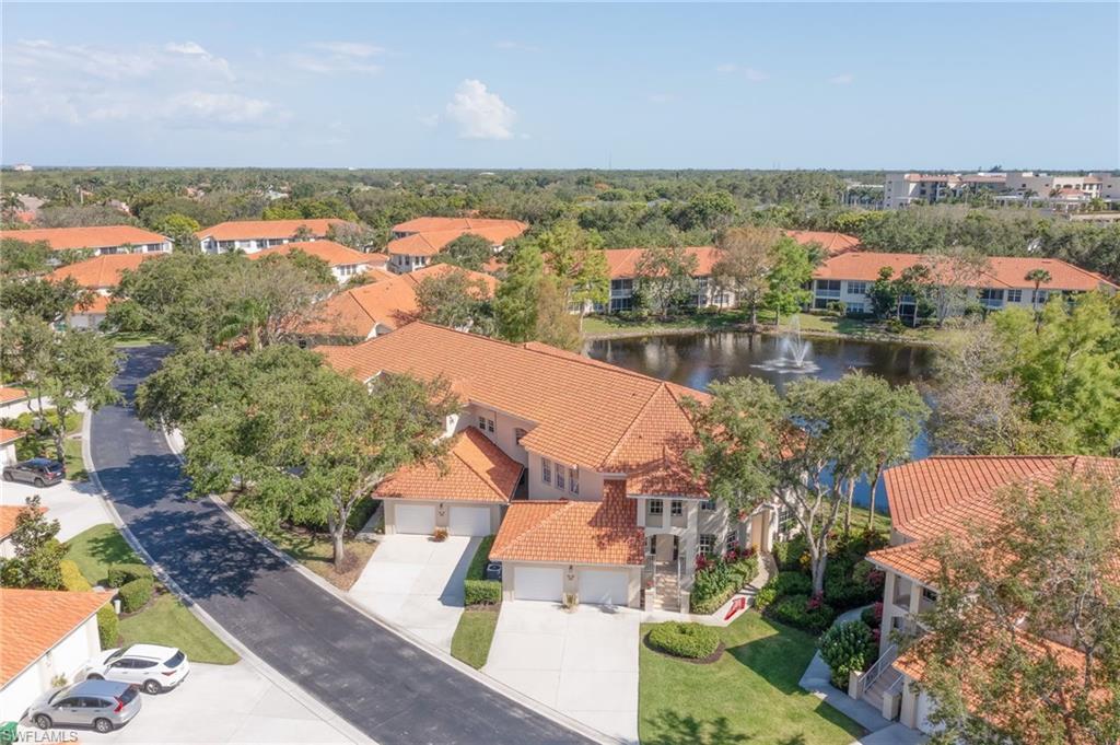 1072 Egrets Walk Circle, Unit 104 Naples, FL 34108 - Photo 1 of 37 an aerial view of a house with a lake view