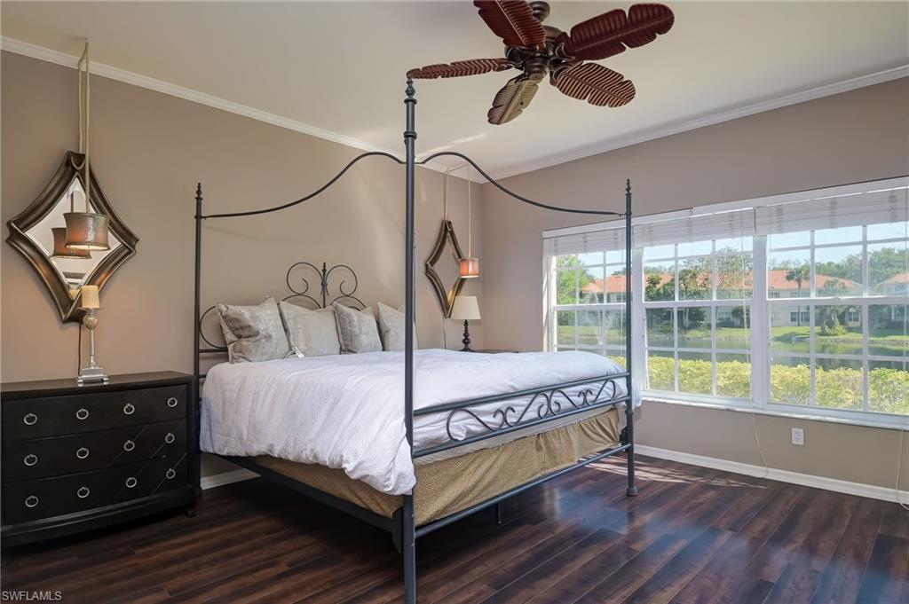 1072 Egrets Walk Circle, Unit 104 Naples, FL 34108 - Photo 16 of 37 a bed sitting in a bedroom next to a window