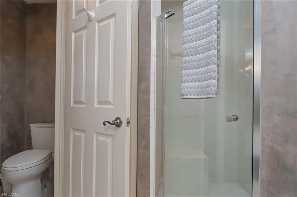 1072 Egrets Walk Circle, Unit 104 Naples, FL 34108 - Photo 20 of 37 a bathroom with a shower curtain