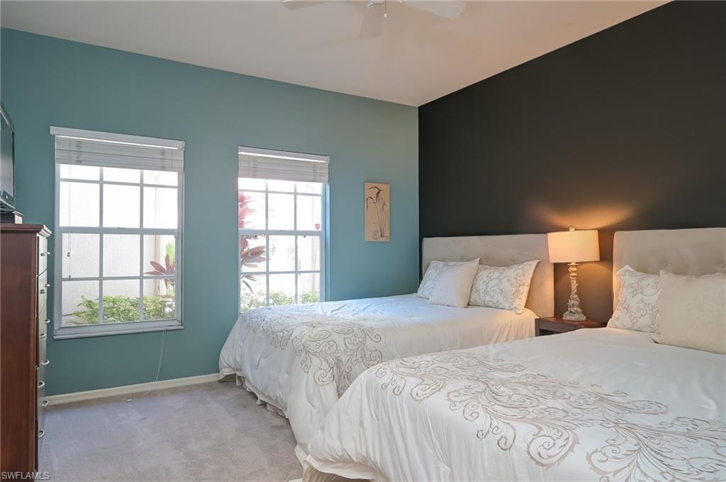 1072 Egrets Walk Circle, Unit 104 Naples, FL 34108 - Photo 24 of 37 a bedroom with a bed and a window