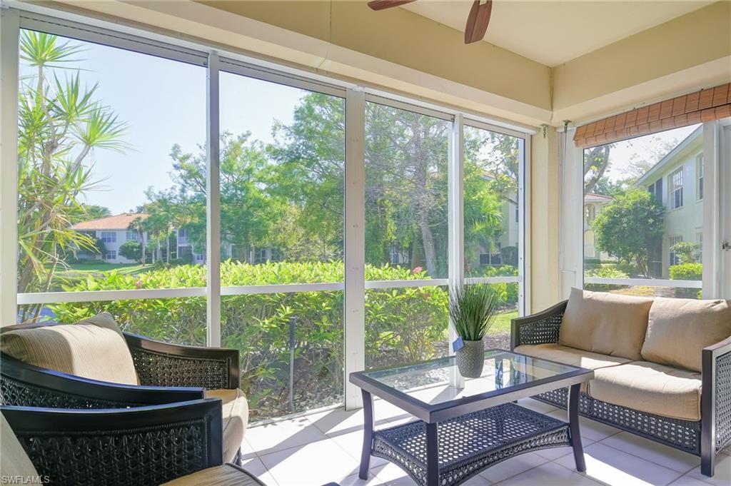 1072 Egrets Walk Circle, Unit 104 Naples, FL 34108 - Photo 27 of 37 a living room with patio furniture and a potted plants